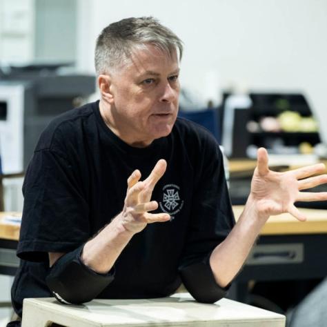 Man sits explaining something