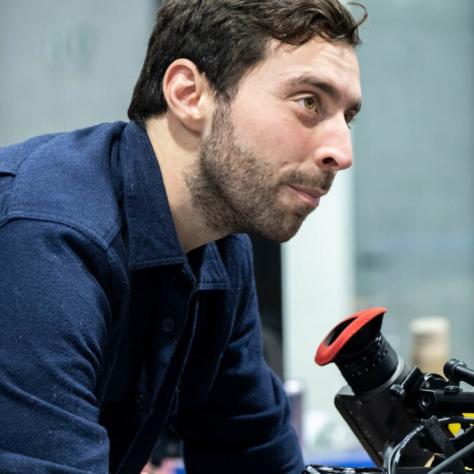 Man with camera demonstrates to students