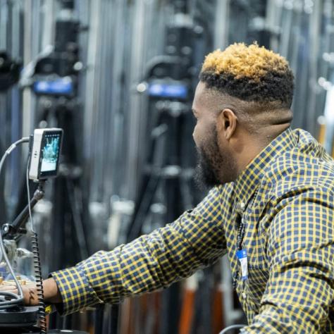 Man looks at a small screen