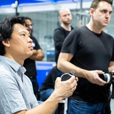 Two men holding small devices
